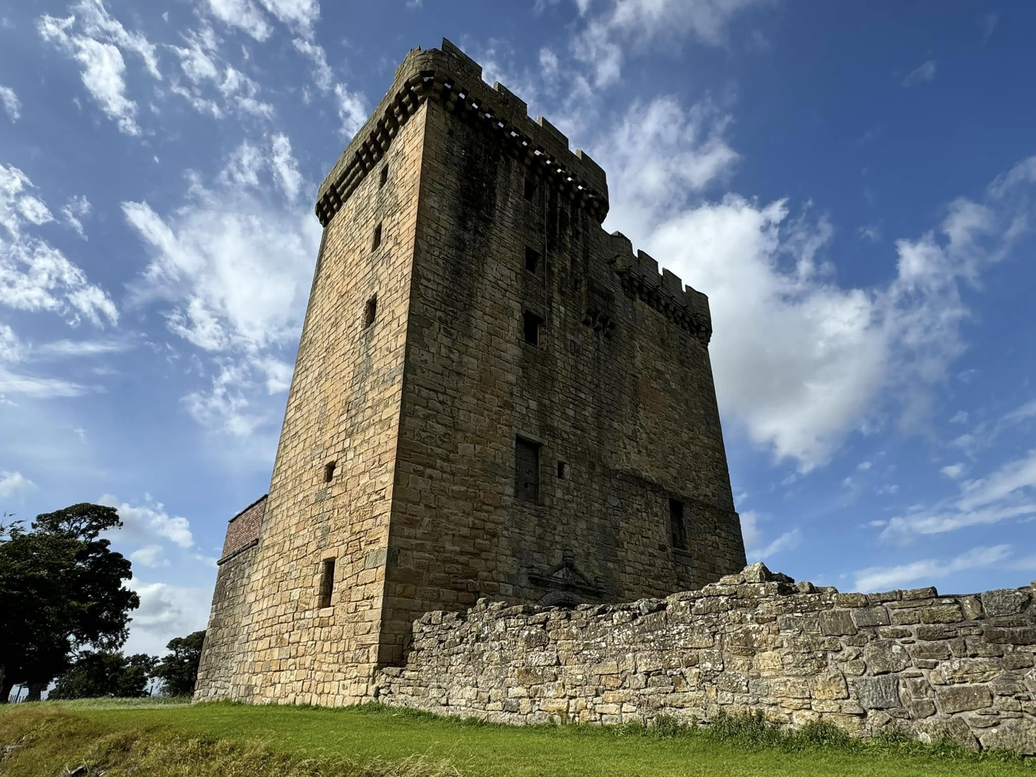 Clackmannan Tower seen from below against a bright blue sky