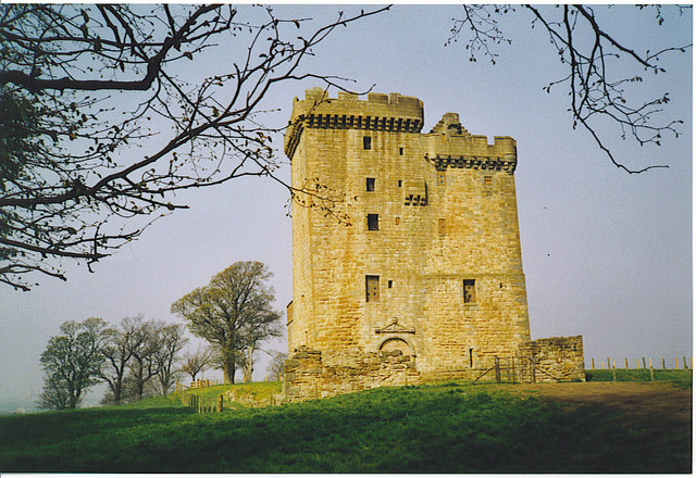 Clackmannan Tower in golden sunlight with bare trees framing the hill